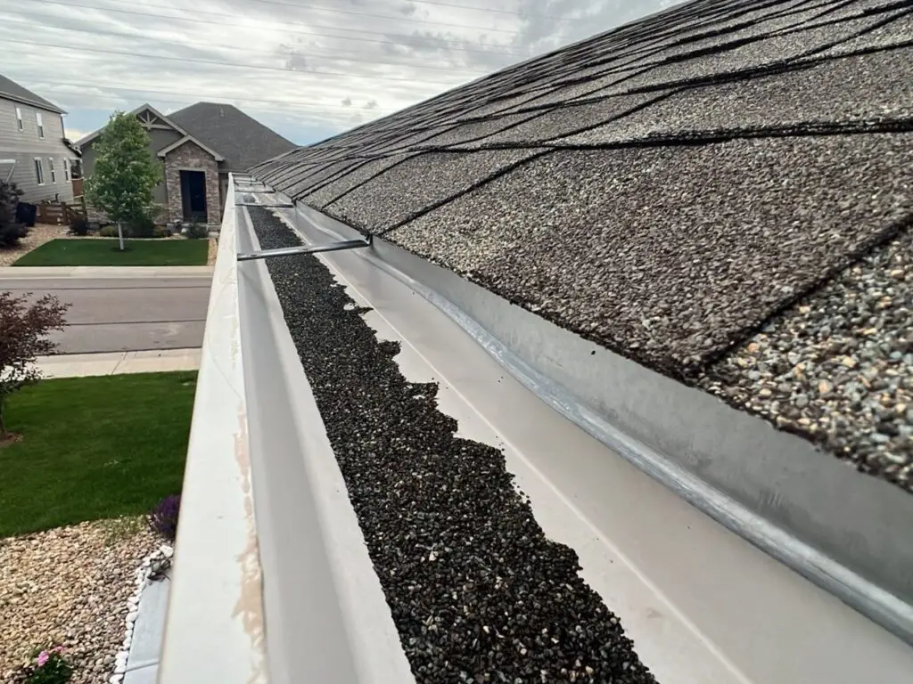 hail-damage-granules-in-gutters